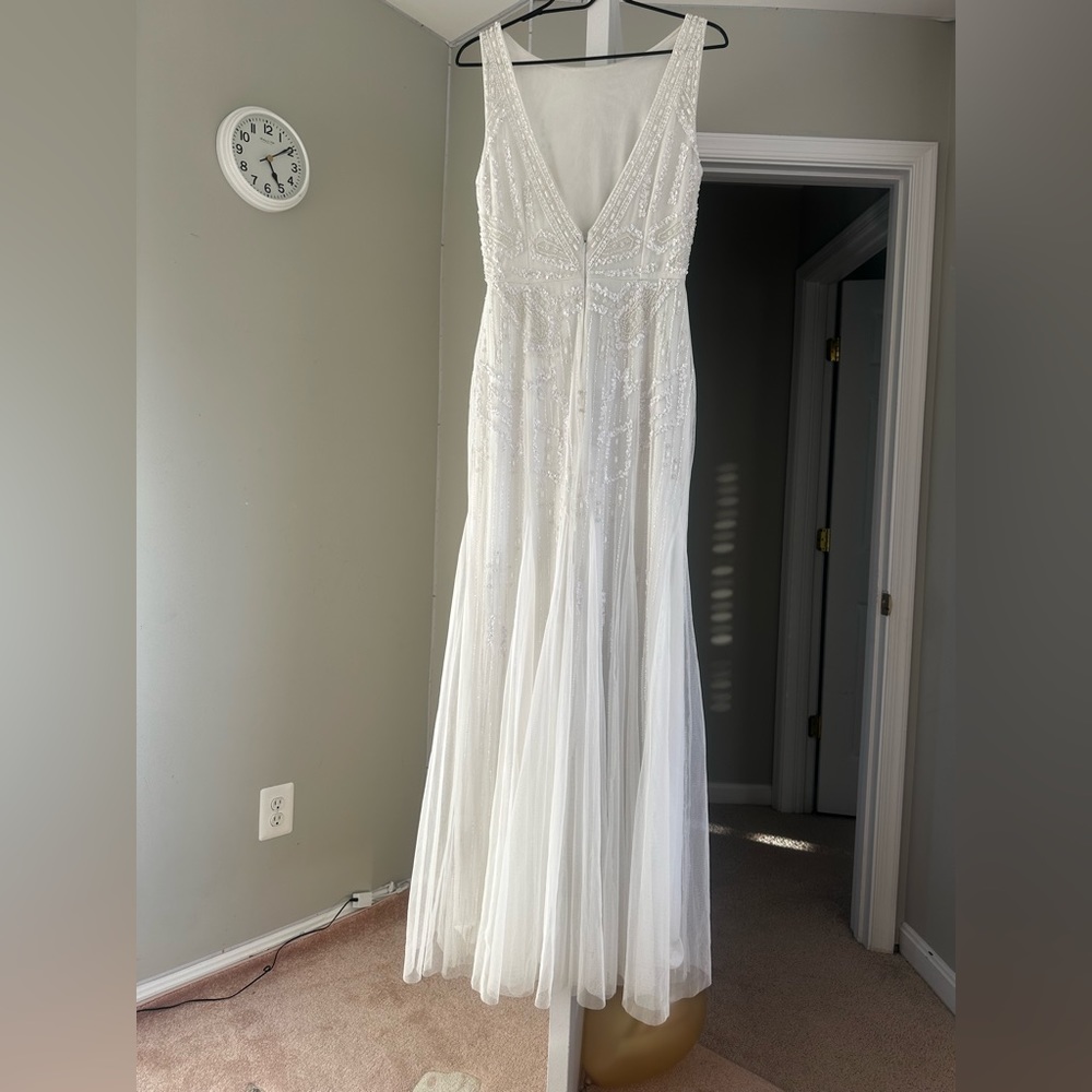 A long, elegant women's prom dress in white, size 6.